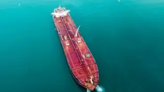 Aerial shot of an oil tanker cruising through the ocean, emphasizing maritime transport.